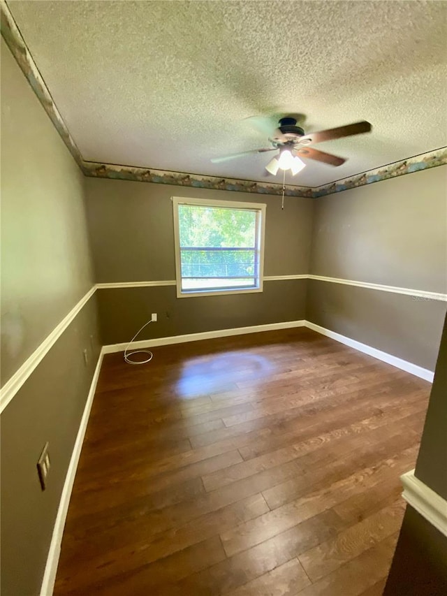 spare room featuring ceiling fan, hardwood / wood-style floors, and a textured ceiling