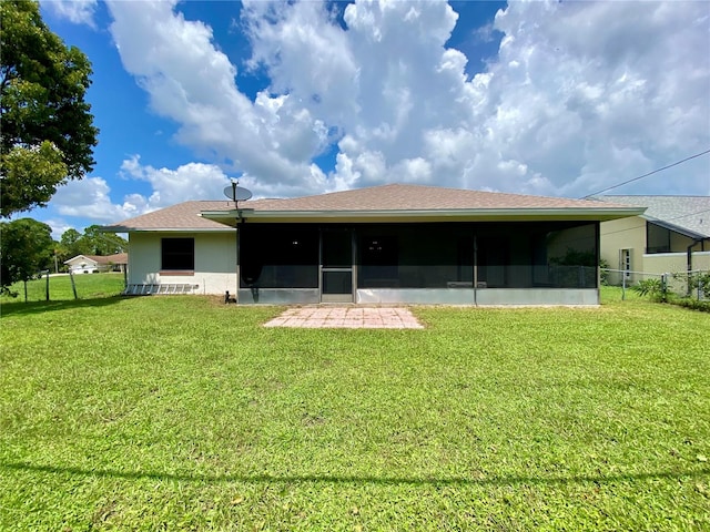 rear view of property with a patio and a yard