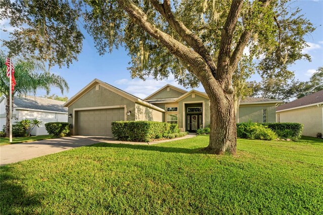 view of front facade with a garage and a front lawn