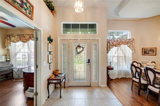 entryway featuring light hardwood / wood-style flooring and a chandelier