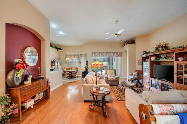 living room featuring light hardwood / wood-style floors and ceiling fan