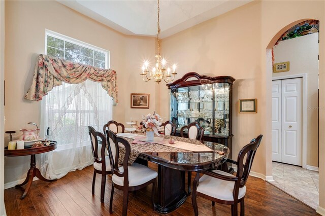 dining area with a notable chandelier and hardwood / wood-style flooring