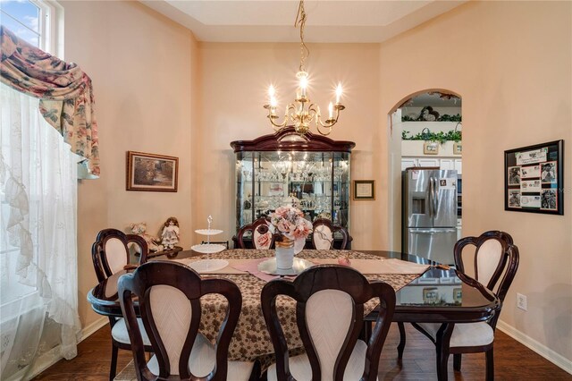 dining room with a chandelier and dark hardwood / wood-style flooring