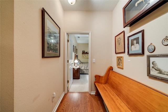 hallway featuring a textured ceiling and hardwood / wood-style floors