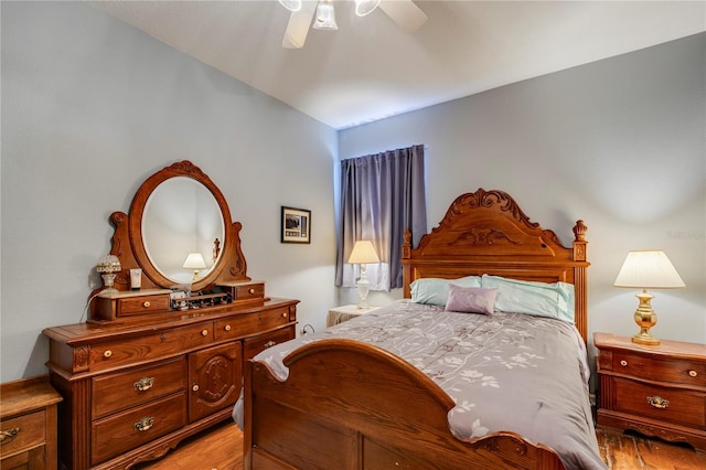 bedroom with light hardwood / wood-style floors and ceiling fan