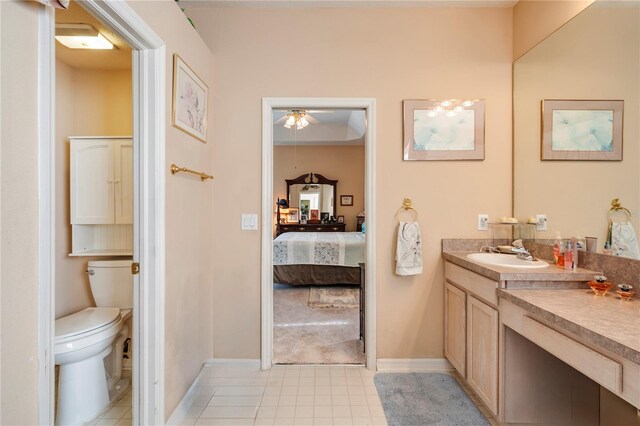 bathroom with tile patterned flooring, vanity, and toilet