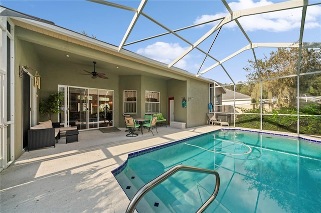 view of swimming pool featuring ceiling fan, outdoor lounge area, a lanai, and a patio