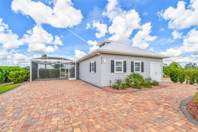 view of home's exterior with a lanai and a patio area