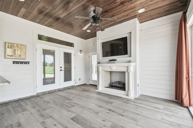 unfurnished living room featuring light wood-type flooring, wood ceiling, and ceiling fan