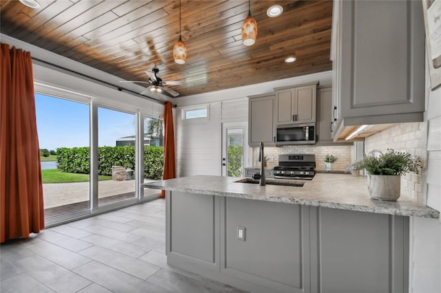 kitchen featuring appliances with stainless steel finishes, hanging light fixtures, wood ceiling, kitchen peninsula, and ceiling fan