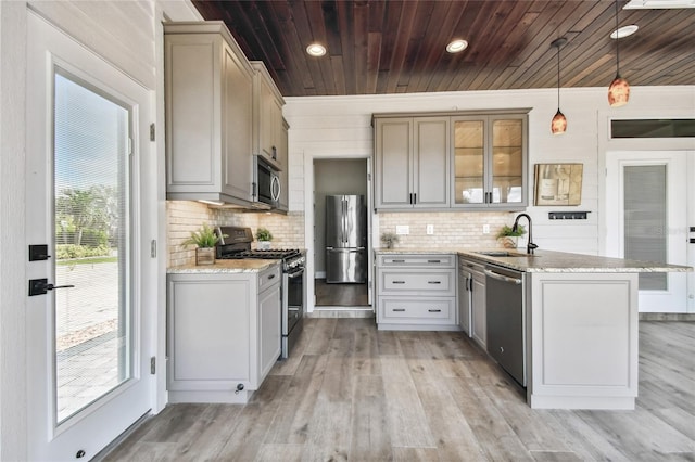 kitchen featuring pendant lighting, stainless steel appliances, sink, and a healthy amount of sunlight