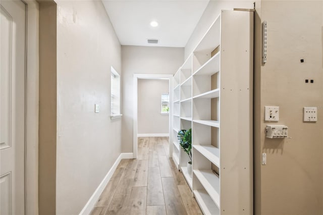 hallway with light hardwood / wood-style flooring