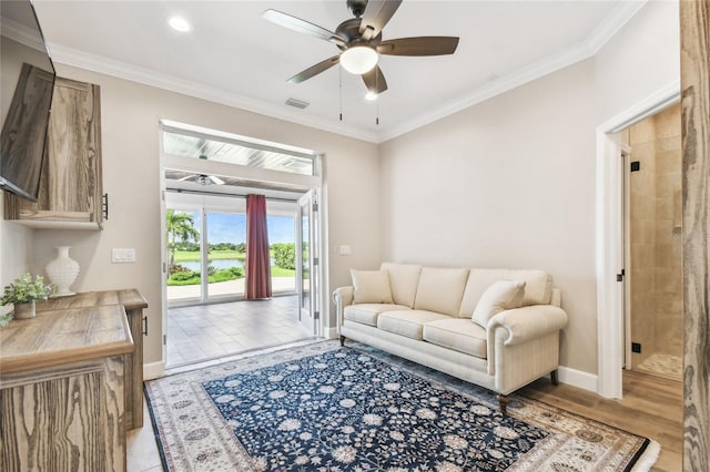 living room with light hardwood / wood-style flooring, ceiling fan, and crown molding