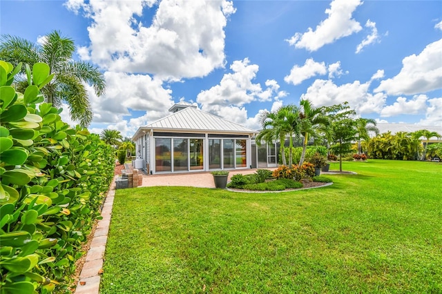 back of property with a sunroom and a lawn