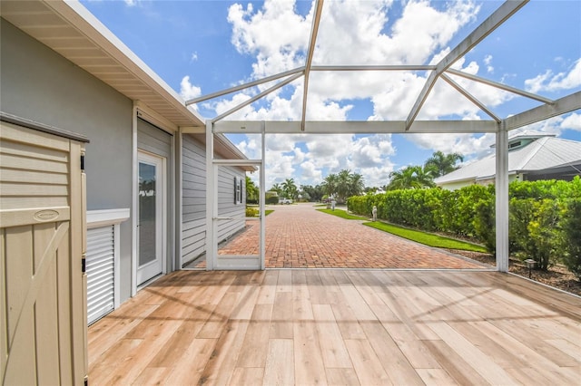 wooden terrace featuring glass enclosure