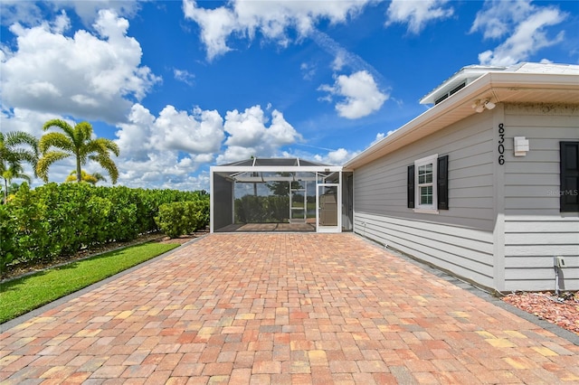 view of patio with glass enclosure