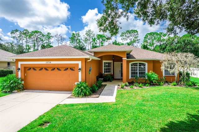 single story home featuring a front yard and a garage