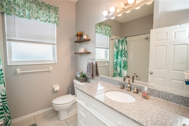 bathroom featuring tile patterned floors, plenty of natural light, vanity, and toilet