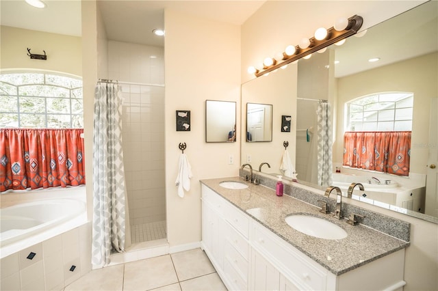 bathroom featuring vanity, shower with separate bathtub, and tile patterned floors