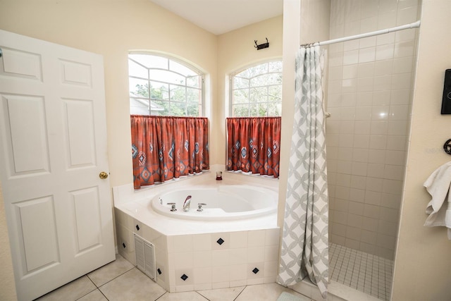 bathroom with separate shower and tub and tile patterned floors