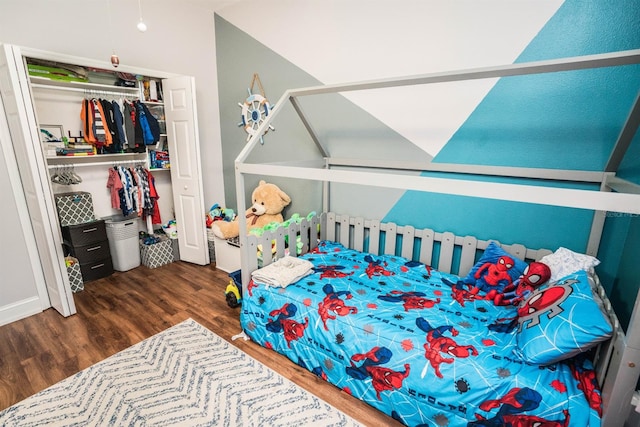 bedroom featuring dark hardwood / wood-style flooring and a closet