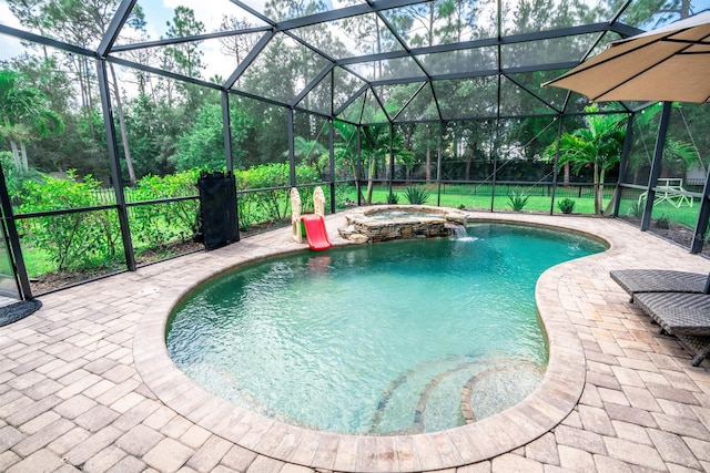 view of swimming pool featuring pool water feature, an in ground hot tub, a lanai, and a patio area