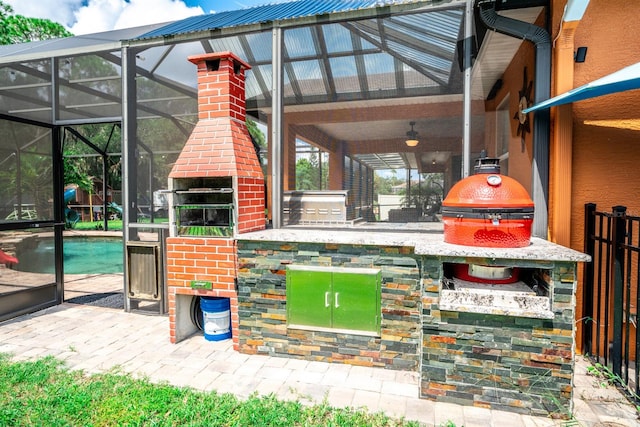 view of patio featuring ceiling fan and glass enclosure