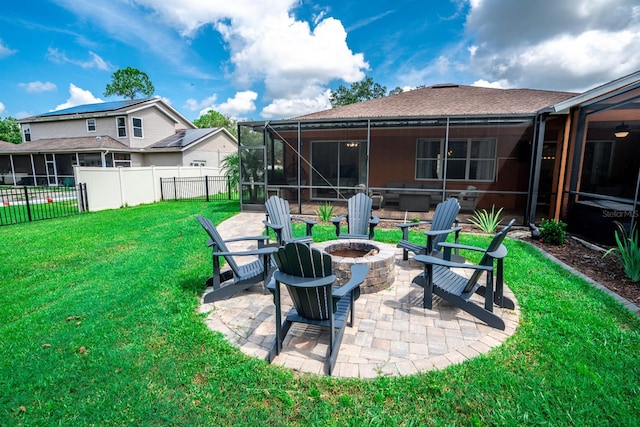 exterior space with a sunroom, a patio area, and a fire pit