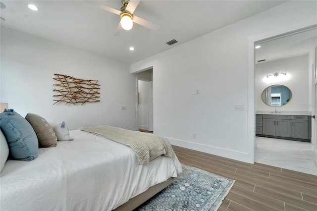 bedroom featuring ceiling fan and ensuite bath