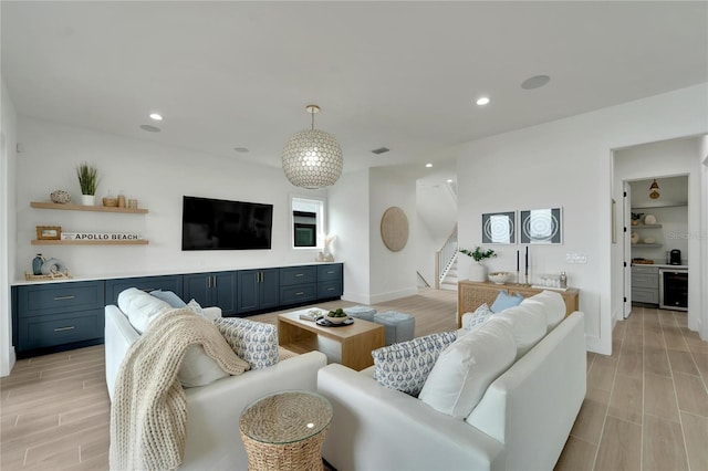 living room featuring beverage cooler and light hardwood / wood-style flooring