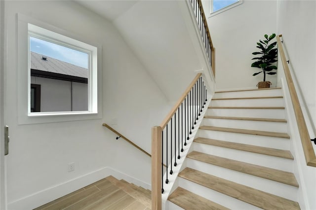 staircase with hardwood / wood-style flooring