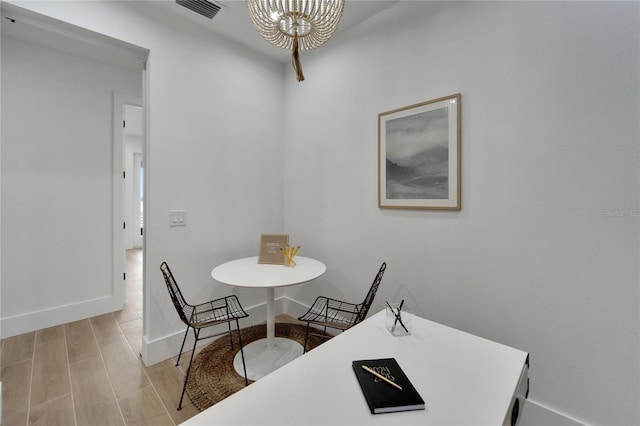 dining area featuring light wood-type flooring and a chandelier