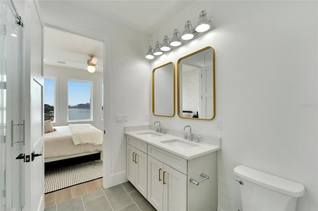 bathroom with vanity, toilet, ceiling fan, and hardwood / wood-style flooring