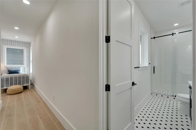 bathroom with an enclosed shower and toilet