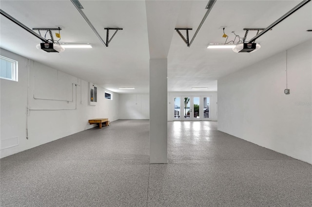 garage featuring electric panel and a garage door opener