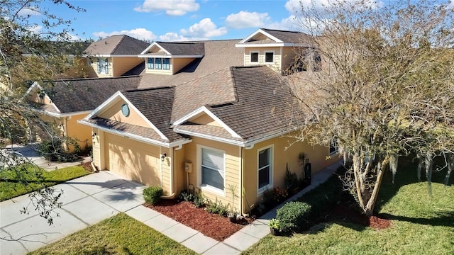 view of front of house with a front yard and a garage