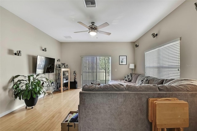 living room featuring ceiling fan and light hardwood / wood-style floors