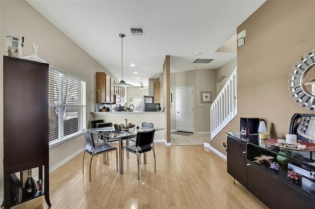 dining area featuring ceiling fan and light wood-type flooring