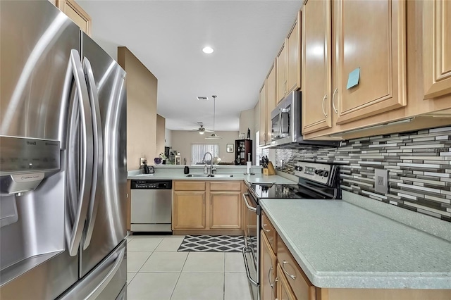 kitchen featuring ceiling fan, sink, stainless steel appliances, kitchen peninsula, and light tile patterned floors