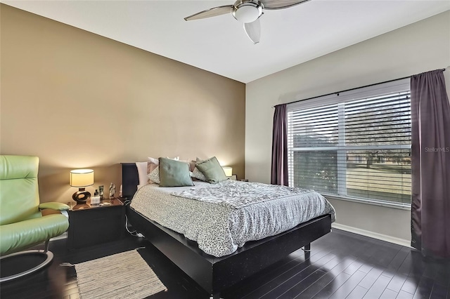 bedroom with dark hardwood / wood-style floors and ceiling fan