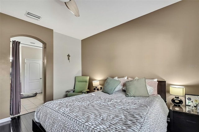 bedroom featuring ceiling fan, lofted ceiling, and light tile patterned floors