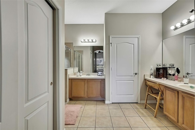 bathroom featuring tile patterned floors, vanity, and walk in shower