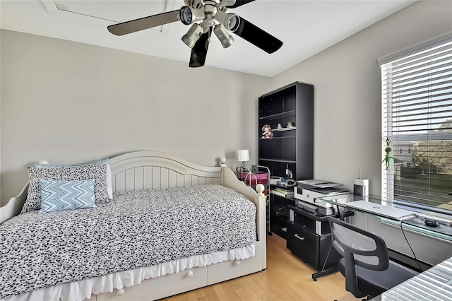 bedroom with ceiling fan and light wood-type flooring