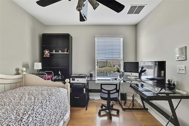 bedroom with hardwood / wood-style floors and ceiling fan