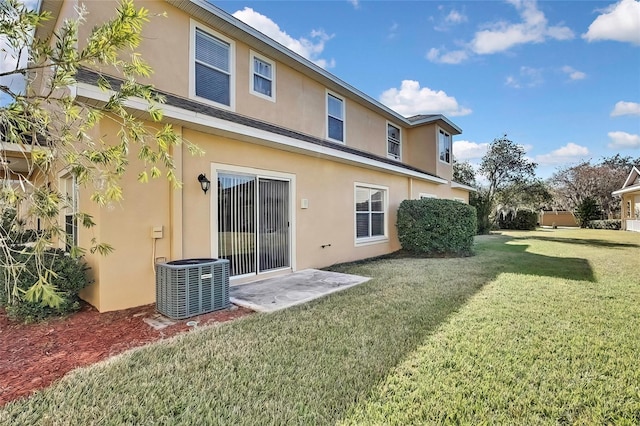 20308 Oak Key Ct, Tampa, FL 33647 - back of house with stucco siding, cooling unit, and a lawn