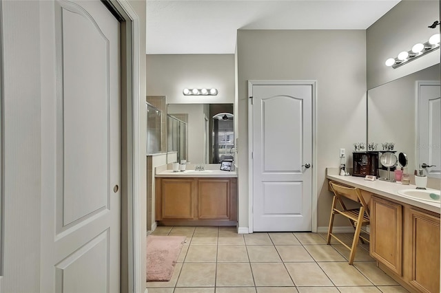 20308 Oak Key Ct, Tampa, FL 33647 - bathroom with tile patterned flooring, a shower stall, and two vanities