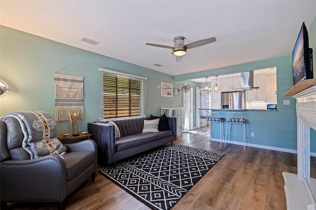 living room with dark hardwood / wood-style flooring and ceiling fan