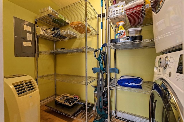 storage area with stacked washer / drying machine and electric panel