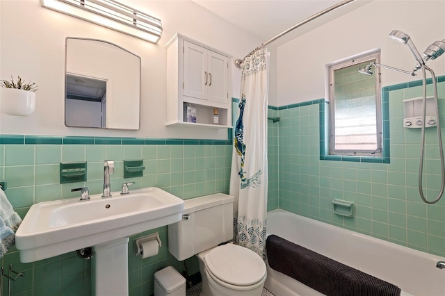 full bathroom featuring toilet, sink, tile walls, and shower / bath combo