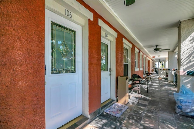 property entrance with ceiling fan and a porch